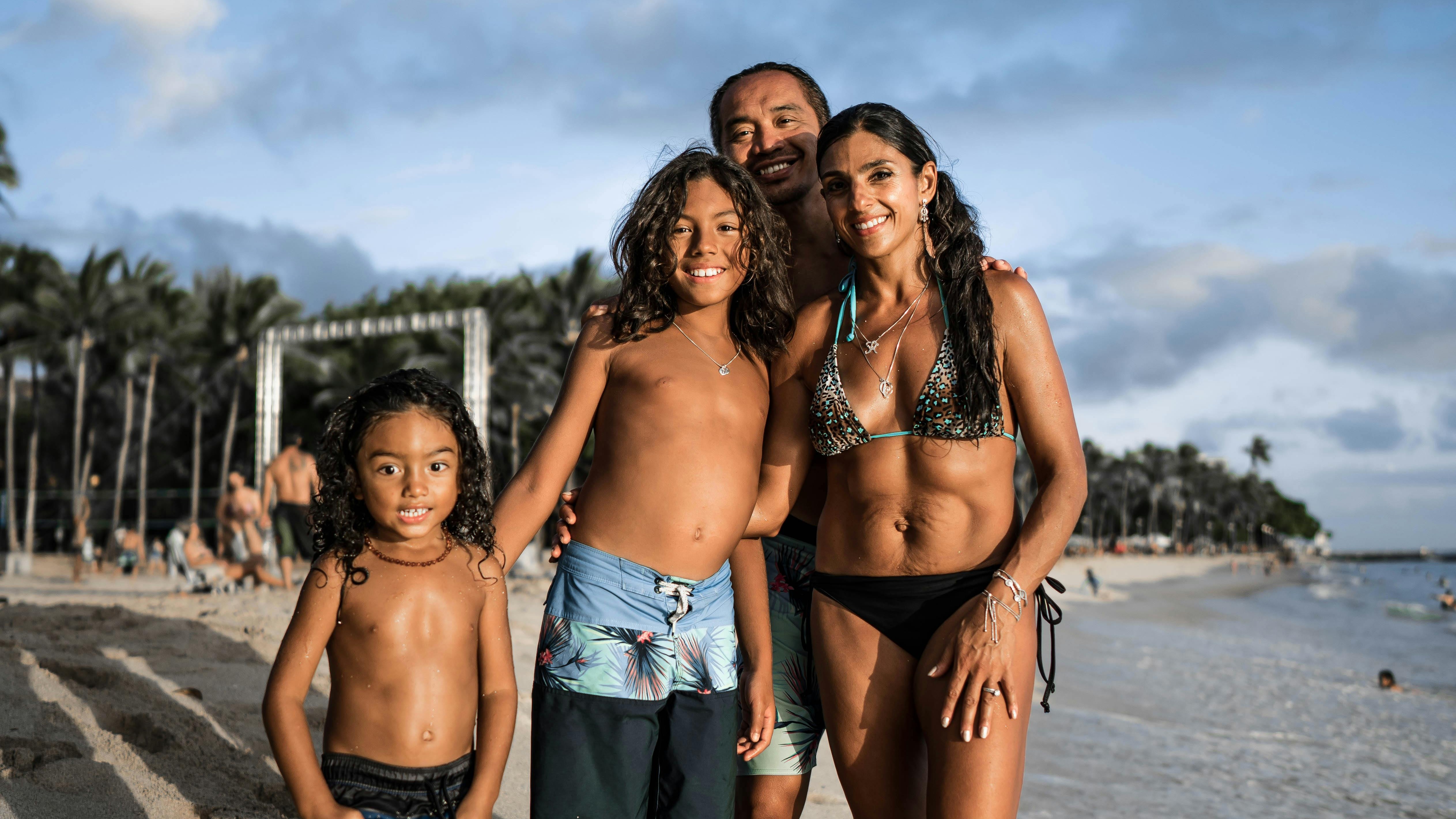 Happy Hispanic family enjoying time together at sunset